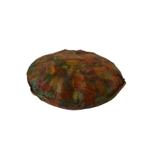 Load image into Gallery viewer, round meditation floor cushion felted with merino wool into silk fabric with tussah silk bamboo accents mixtures of various shades of green, rust, and patina, cooper and teal shimmery accents. bottom side of cushion
